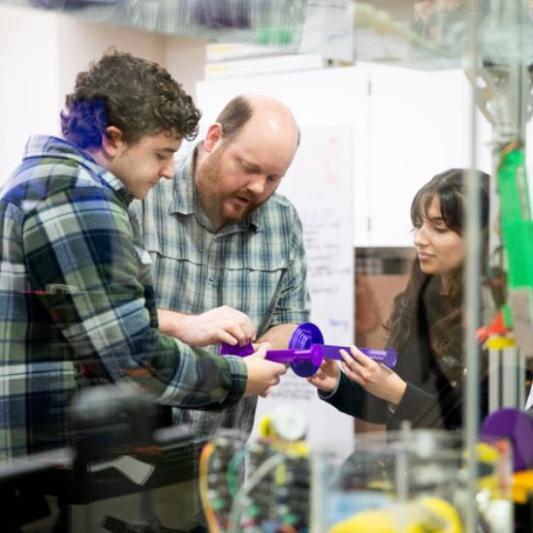 students in chemistry class with teacher