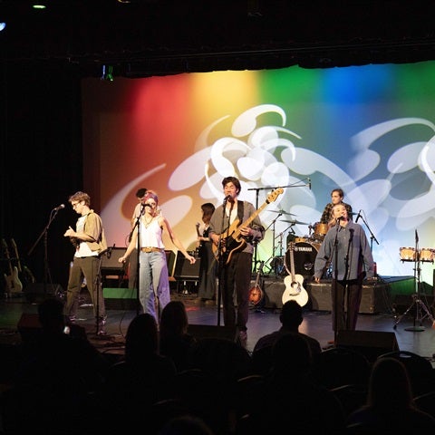 Students playing music on stage