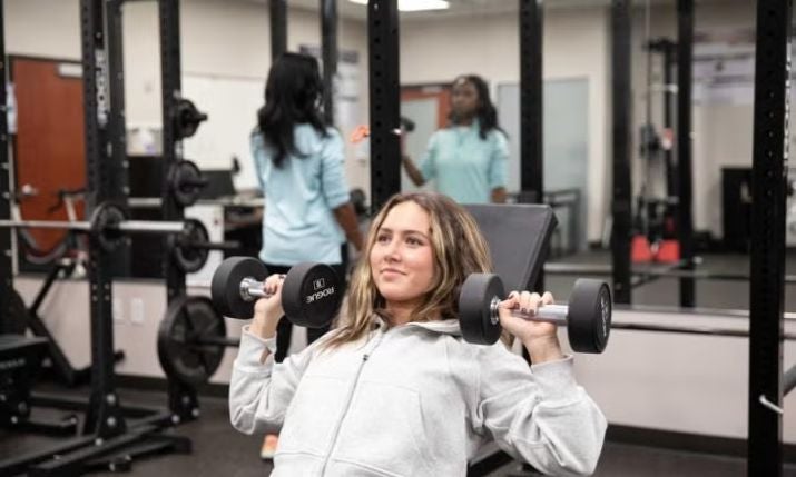 student lifting weights