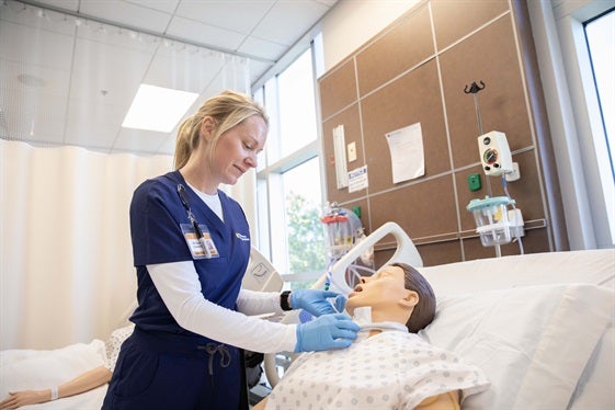 A student nurse helps his "patient".