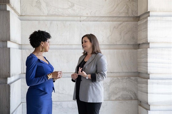 mentor speaking with student outside of the State Capitol