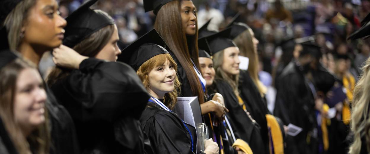 student smiling at graduation