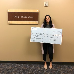 Angelica Barrios with a scholarship check