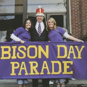 Former President Randolph Lowry with students and the Bison Day Parade banner