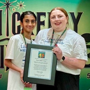 Abigail Hardage receiving the Best Buddies chapter award