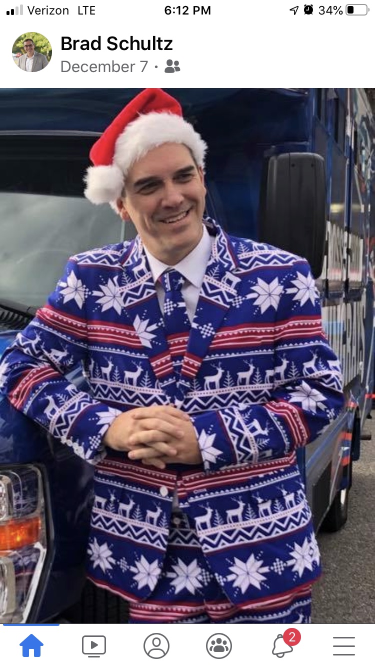 Dr. Brad Schultz wearing a Christmas suit