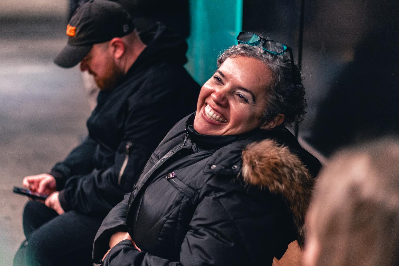 a woman smiling on the subway