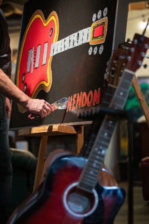 One of Hendon's guitars leaning against his latest guitar painting