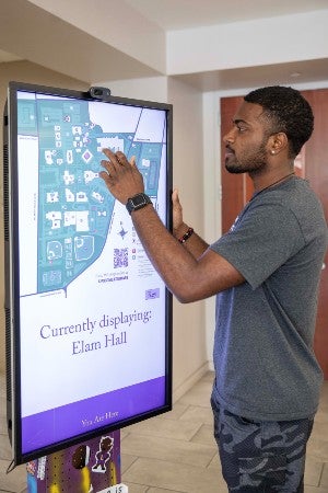 Student works on the L.U.K.E. map kiosk