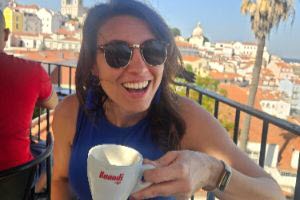 girl drinking coffee in Europe at an outdoor cafe