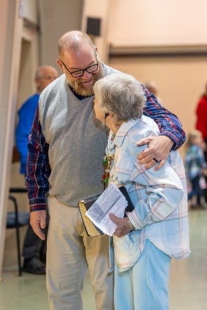 Members of the Sulphur Well church hugging