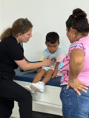 Health workers with a patient in the Predisan clinic in Honduras