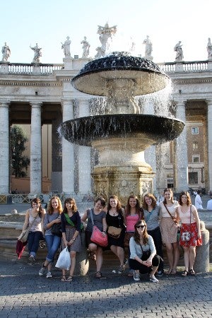 students in Vienna posing in front of an elegant fountain