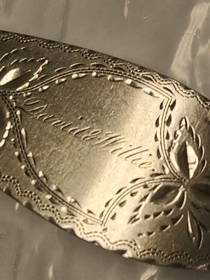 the inscription "David and Willie" on the olive spoon at Two River Mansion.