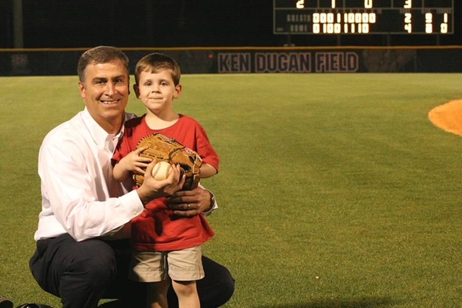 A young Will Dugan with his dad, Mike, on the field named for his grandfather, Ken.