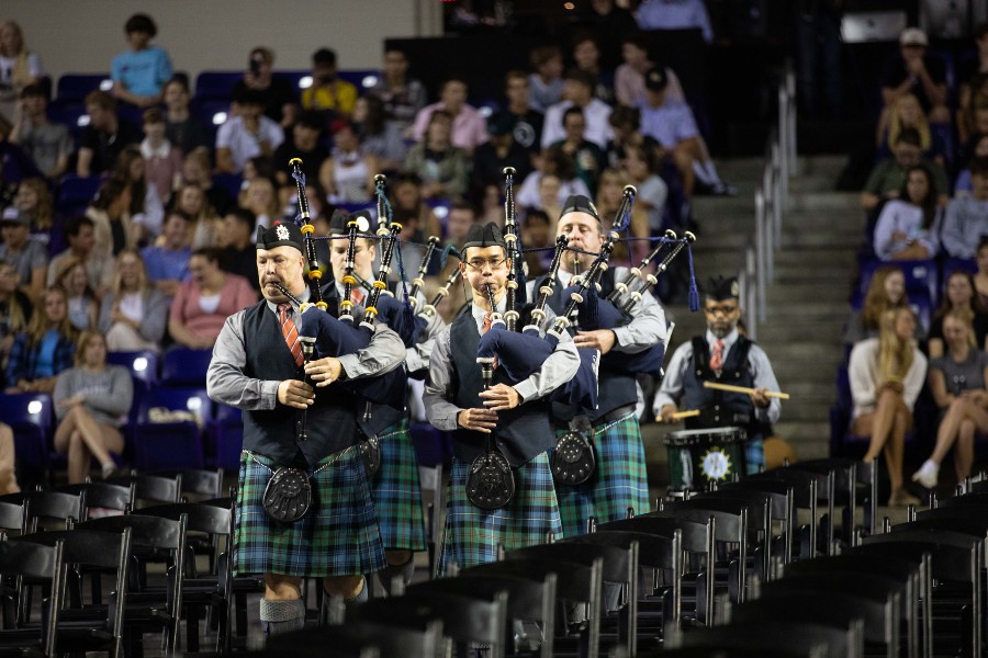 The bagpipe ensemble marches into Allen Arena at Convocation