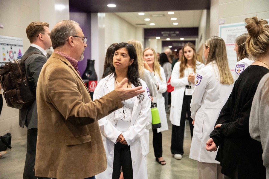 Honors Dean Alan Bradshaw discussing a student's research at Lipscomb's Student Scholars Symposium. 