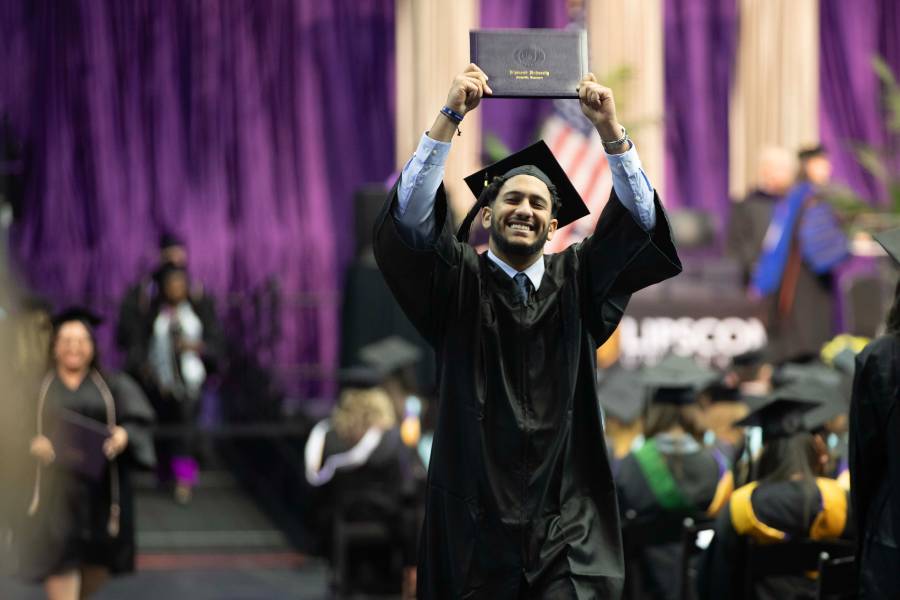 graduate holding diploma