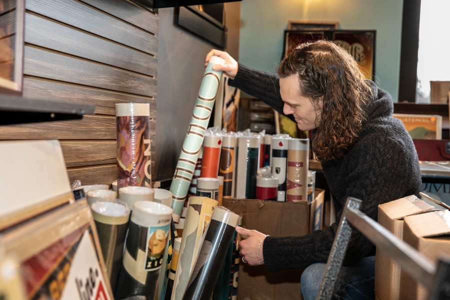 Nathan Anderson looking through ADG posters for sale