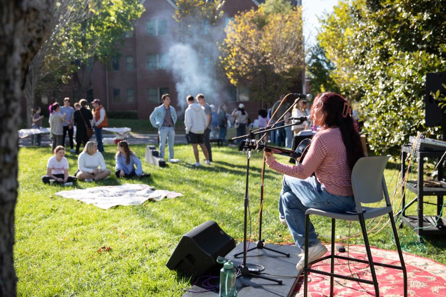 student singing on the lawn