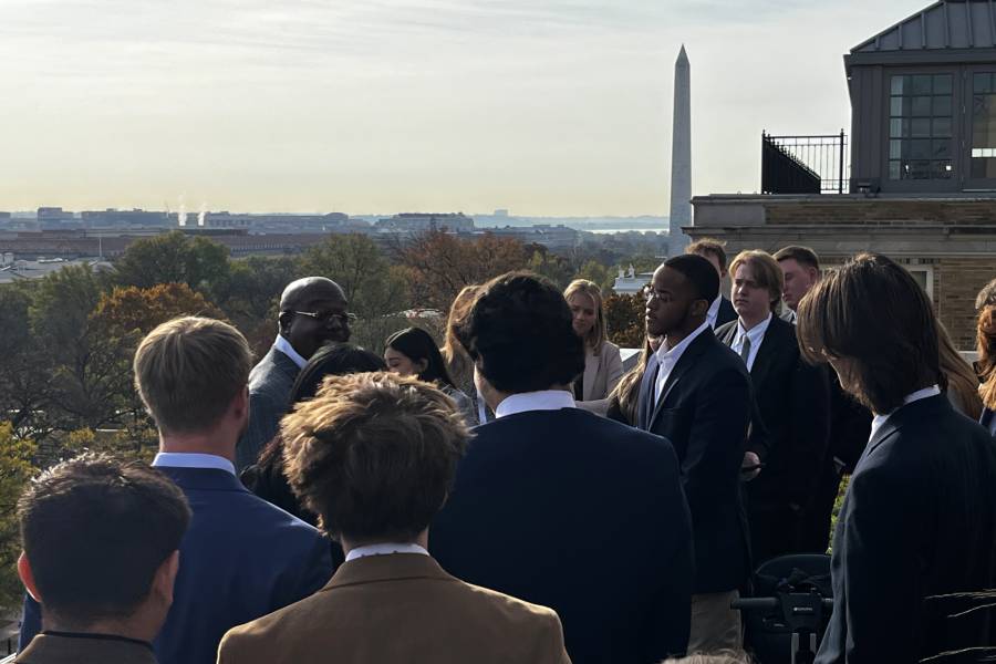 Students on the steps in Washington, DC with the Washington Monument in the background. 