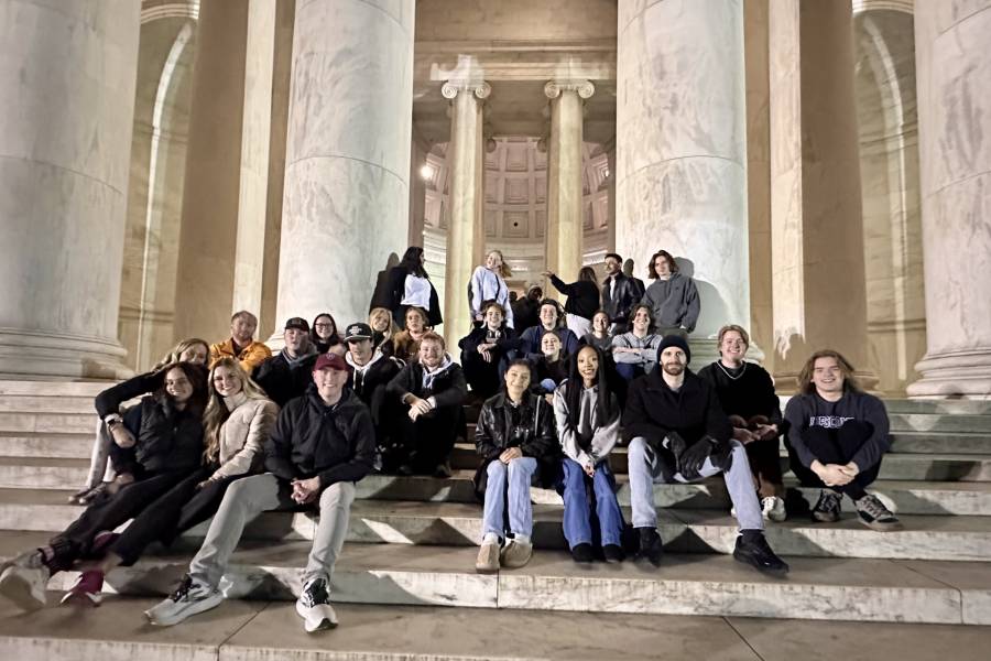 Students sitting on the steps during a tour of DC. 