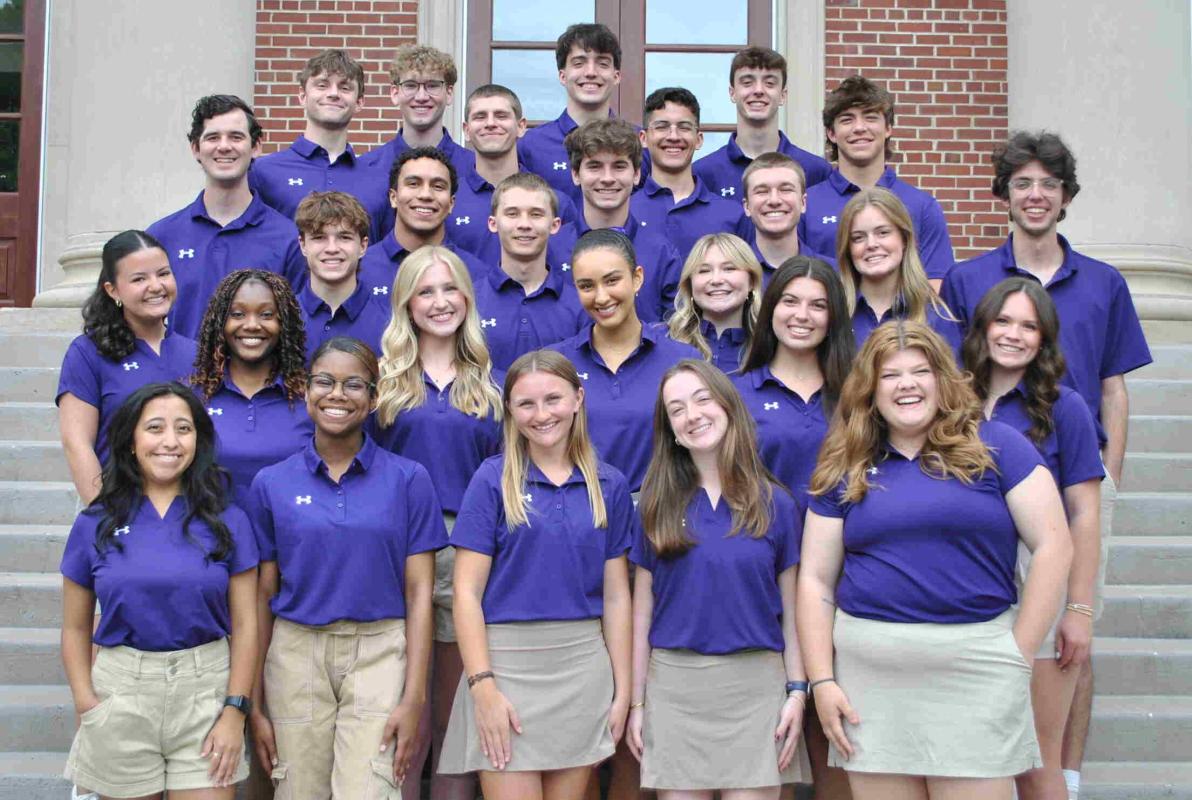 The Quest Team stands in front of Collins Alumni Auditorium