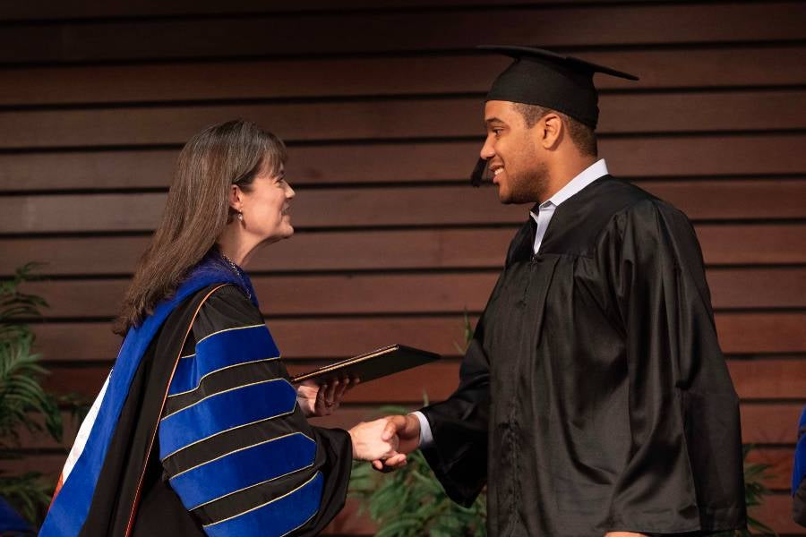 President McQueen awarding diplomas at the ceremony.