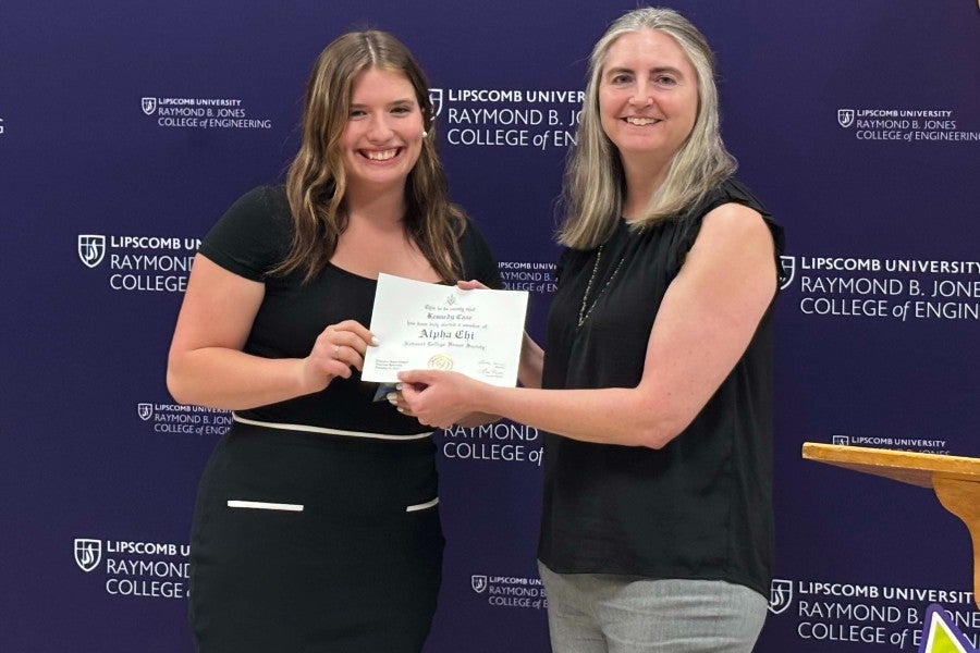 Kennedy Case receiving a certificate from Porf. Monica Sartain