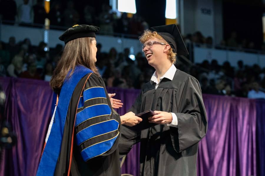 Sean Worth shaking hands with Dr. McQueen