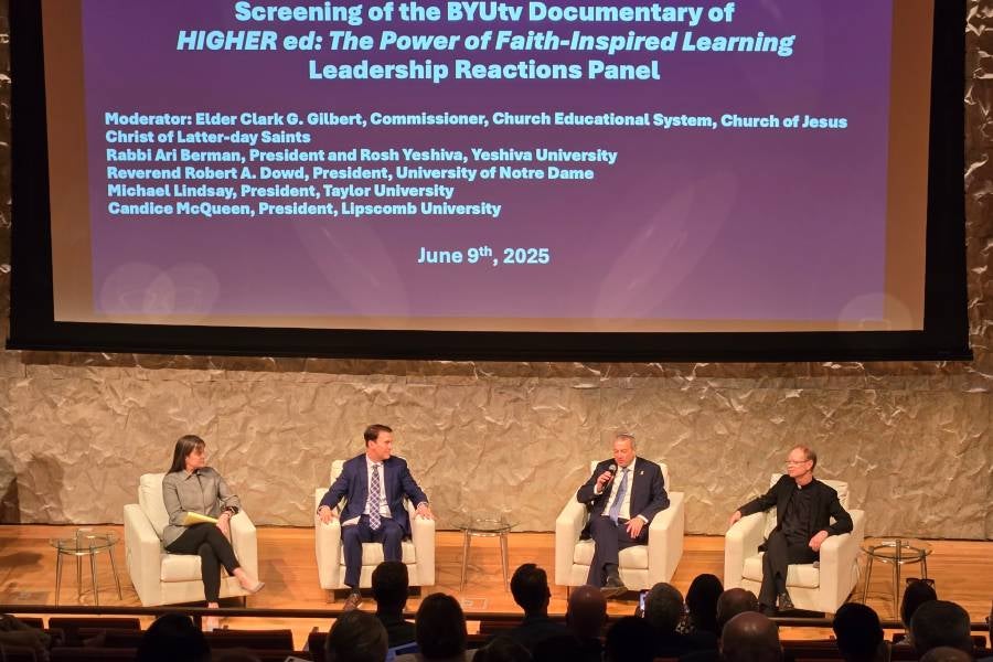 Dr. McQueen participating in a panel discussion with three others.