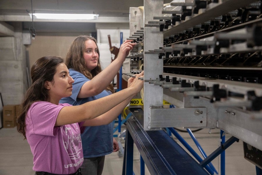 Student interns working with the university's wind tunnel