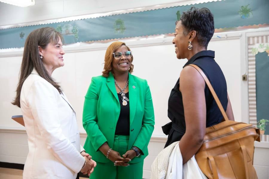 President McQueen and Commissioner Thomas meet with guests at the ECE hub announcement.