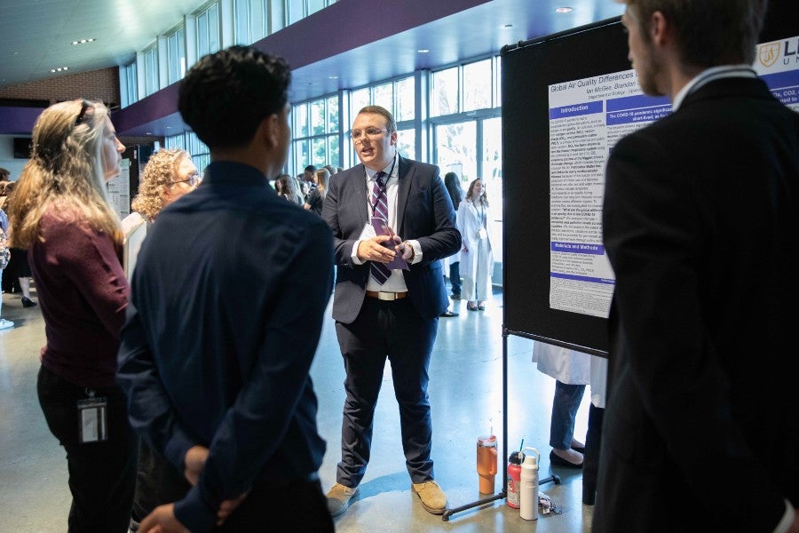 Jude Spencer presents his poster at the Student Scholars Symposium