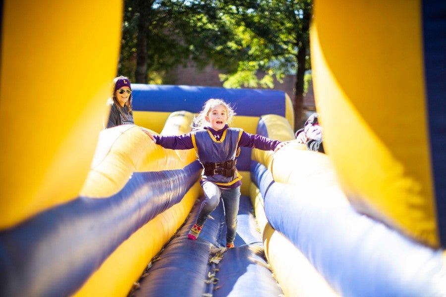 A youngster plays on the inflatable games at the Bison Square Fair.