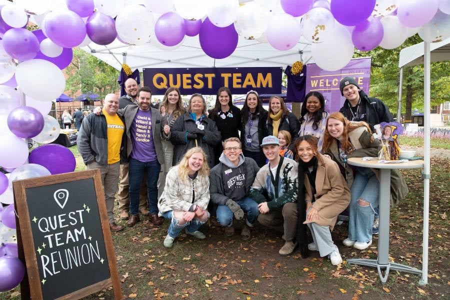Alumni gathered at the Quest team booth for reunion