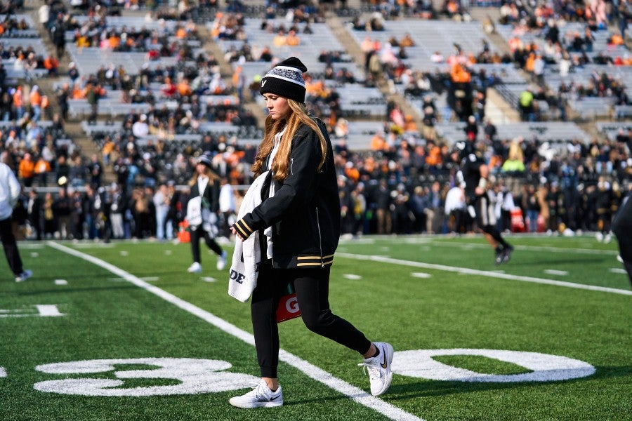 Cameron Neal walking onto the field in a football stadium before a game