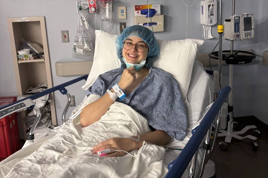 Chloe Butler laying in hospital bed. 