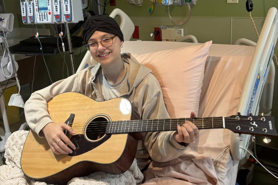 Chloe playing guitar. 