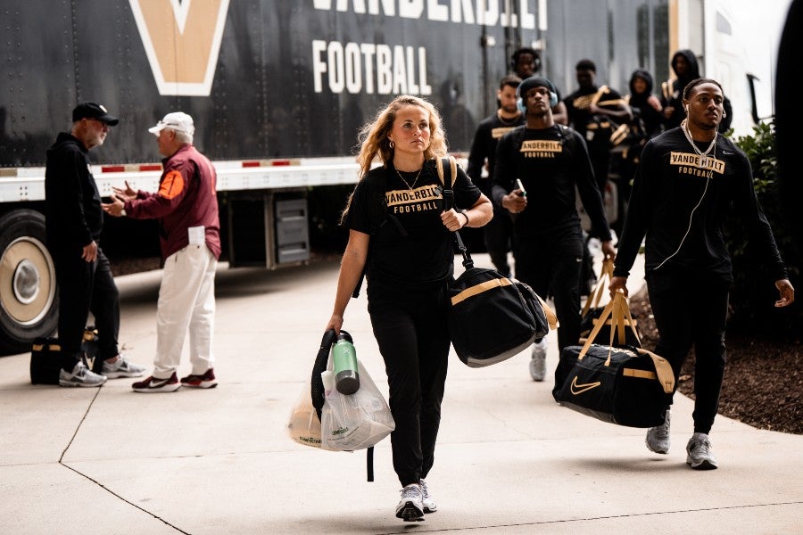Cameron Nill deboarding the team's bus with the football players