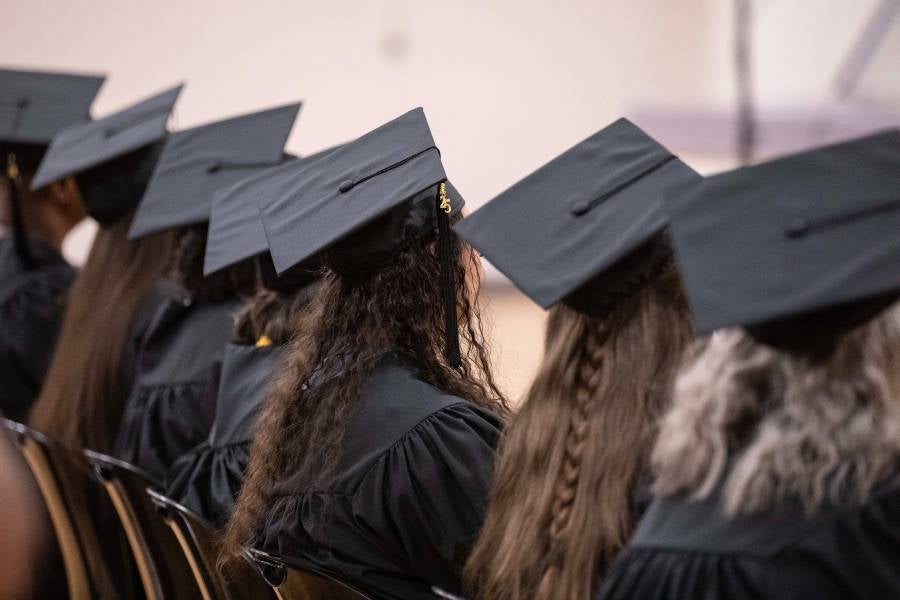 Row of heads of graduates wearing their caps. 