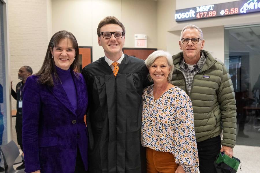 Lipscomb President Candice McQueen with Tucker Hamar and his parents, Amy and Chuck, at the PA School hooding ceremony on Dec. 12.