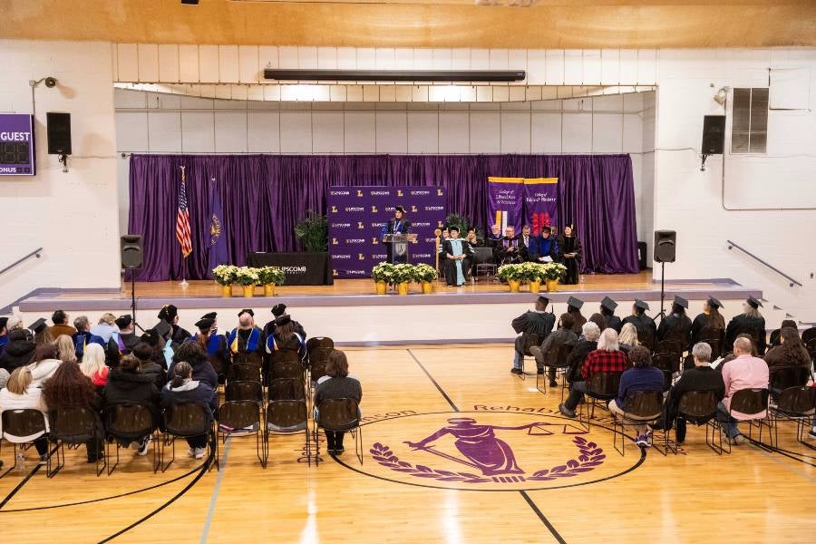Dr. McQueen addresses the graduates. 
