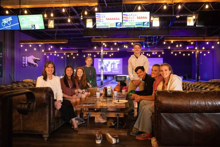 Students and Lipscomb President Candice McQueen seated at a Chattanooga Be A Bison event. 