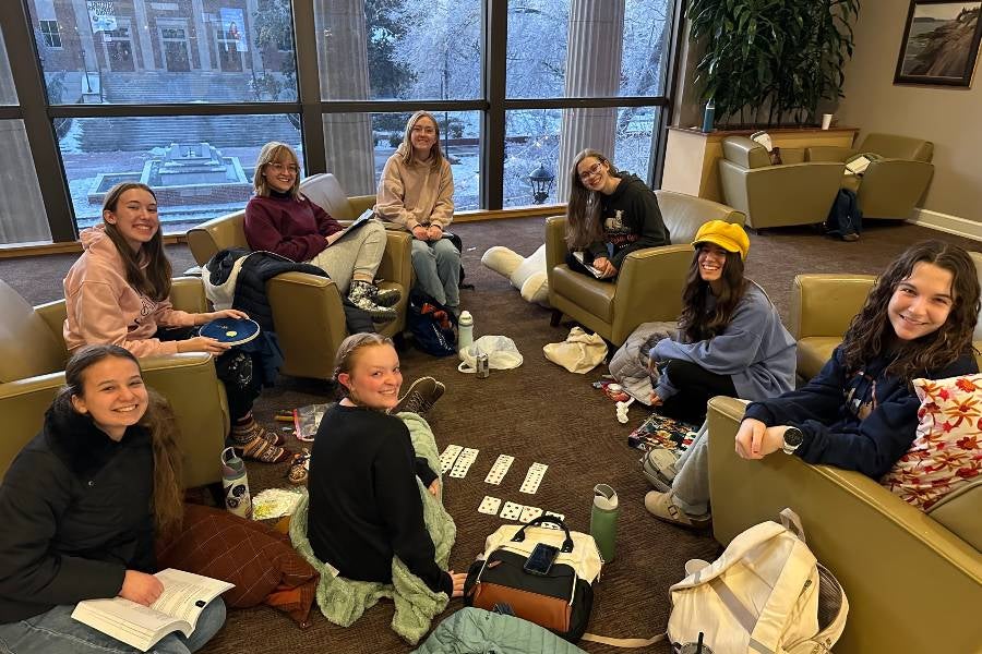 Students playing cards in Bennett. 