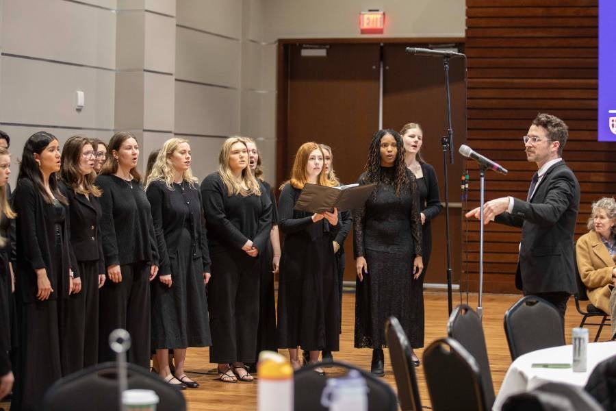 Members of the Lipscomb University Chorale standing and singing under the direction of Matt Taylor. 