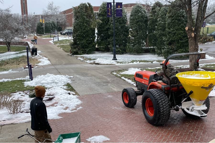 Maintenance team out salting sidewalks. 