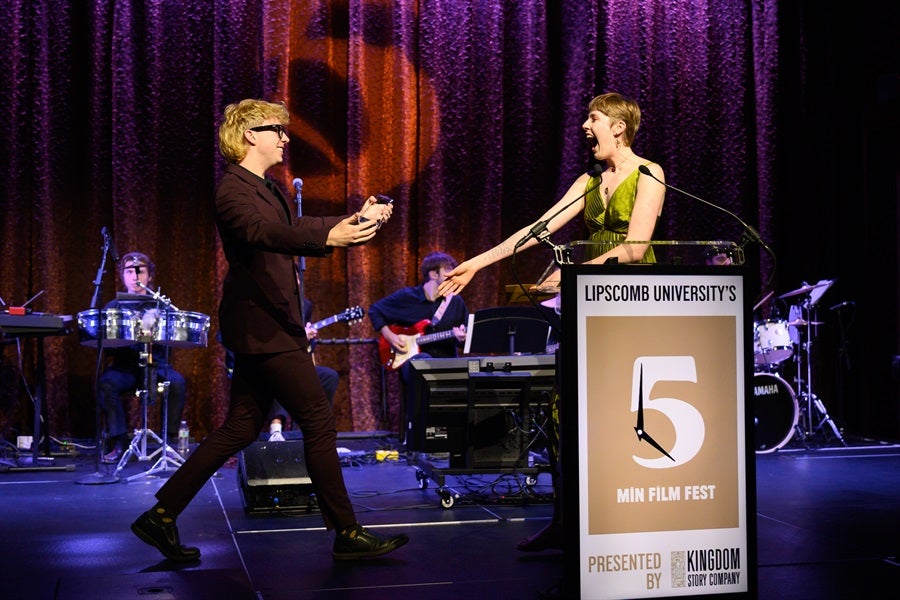 man accepting award from woman
