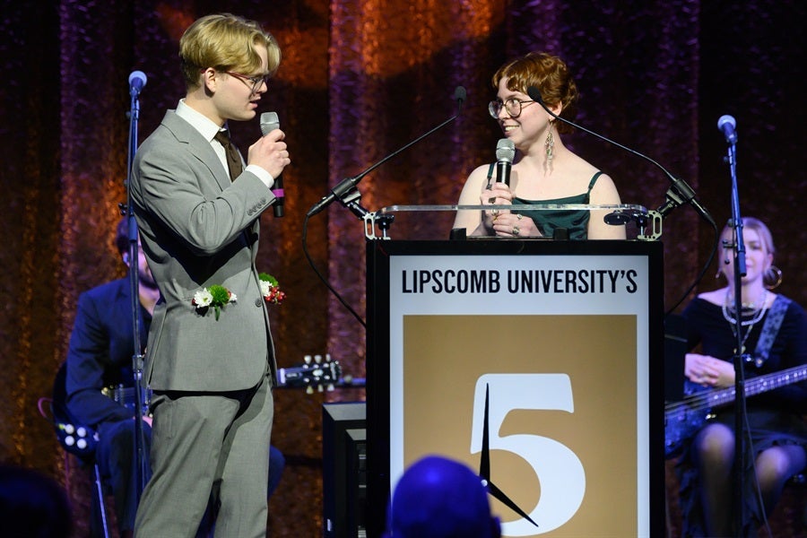 man accepting award from woman