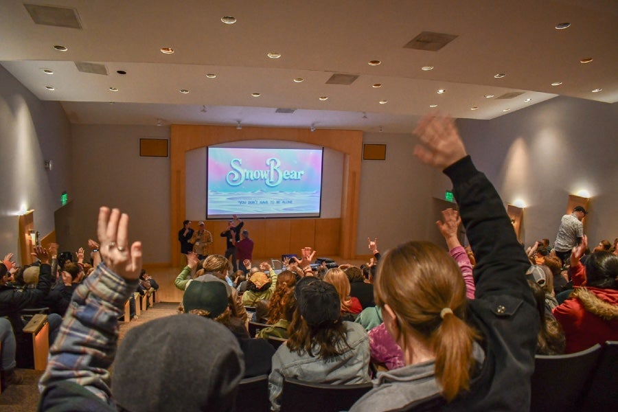 A full audience in Ward Lecture Auditorium screening an animated film. 